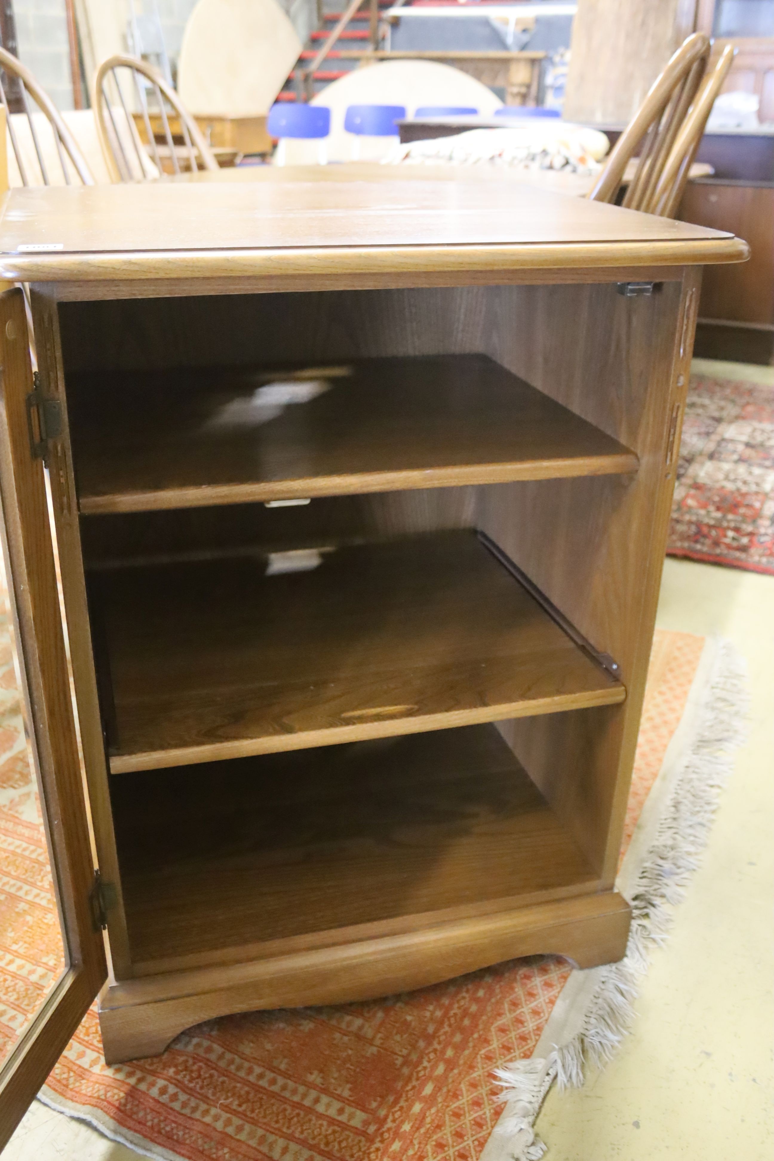 An Ercol glazed elm media cabinet, width 63cm, depth 53cm, height 82cm